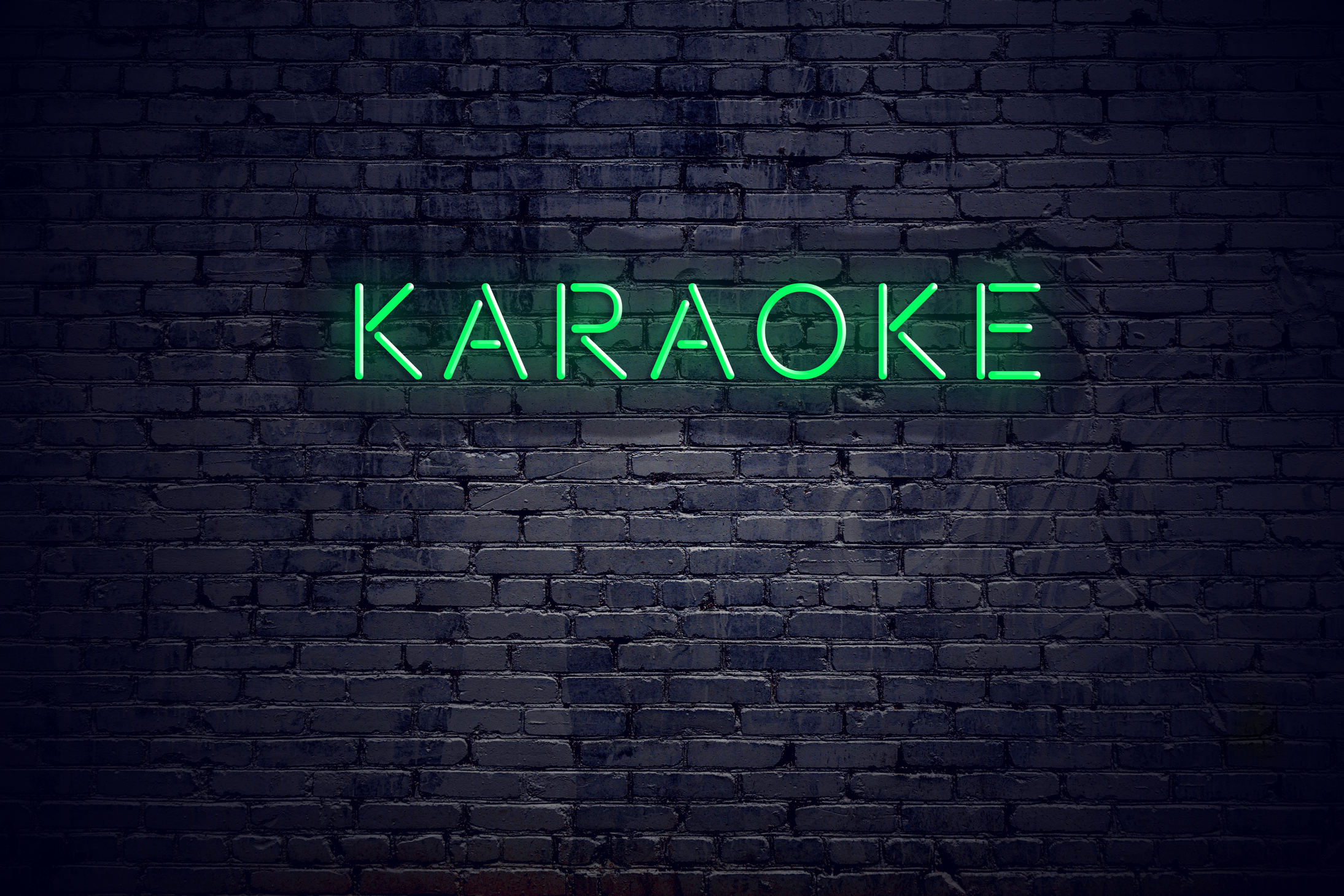 Brick wall at night with neon sign karaoke